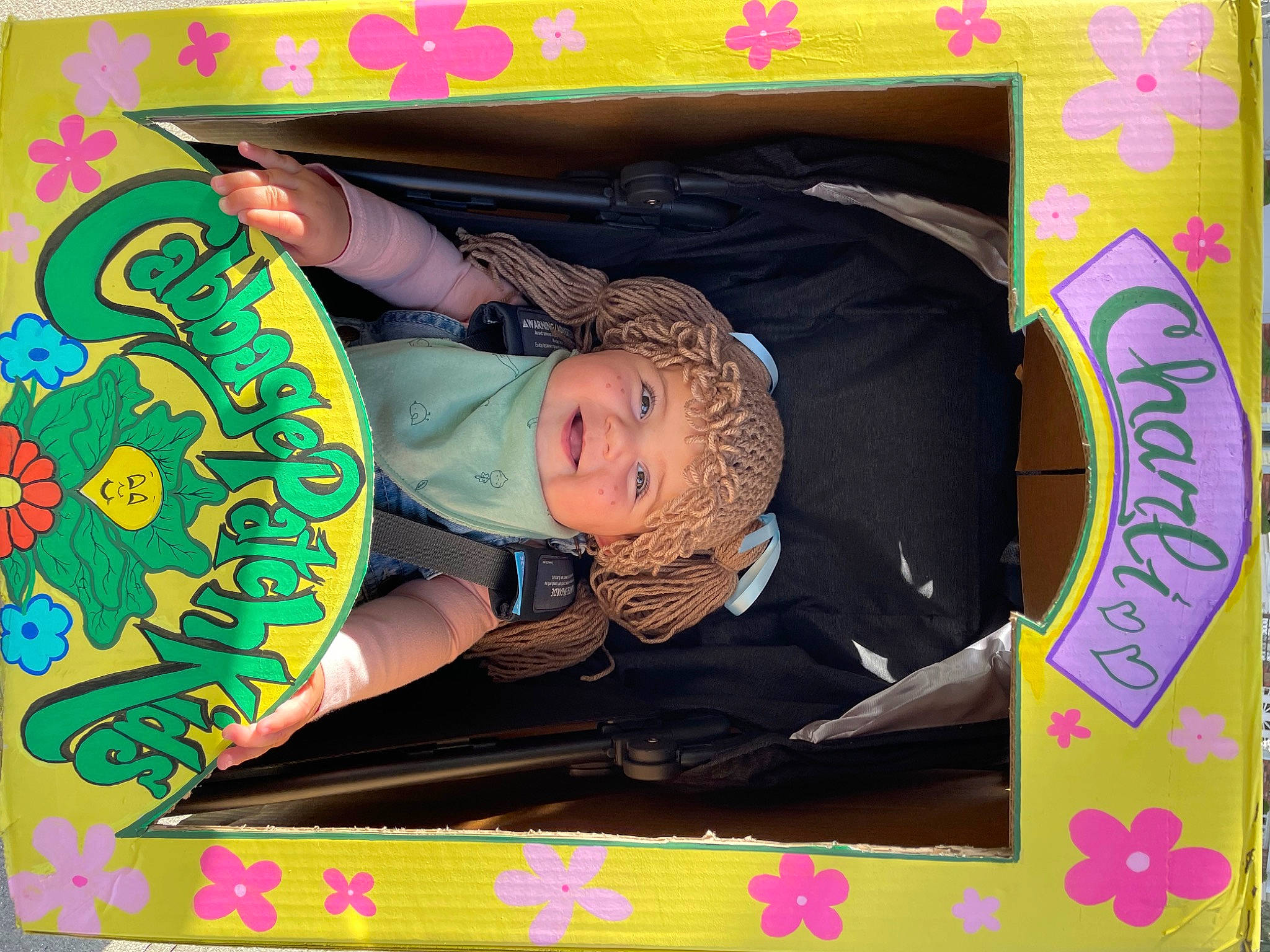 Charli is registered to the contest to win money with this photo: art, baby_products, black, child, circle, font, fun, graphic_design, green, headwear, joy, magenta, pattern, person, pink, play, rectangle, room, sitting, toddler