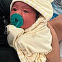 Amelia is registered to the contest to win money with this photo: baby, infant, pacifier, blanket, hood, yellow, striped, soft, cute, face, person, holding, hand, indoor, clothing, child, newborn, resting, comfort, closeup