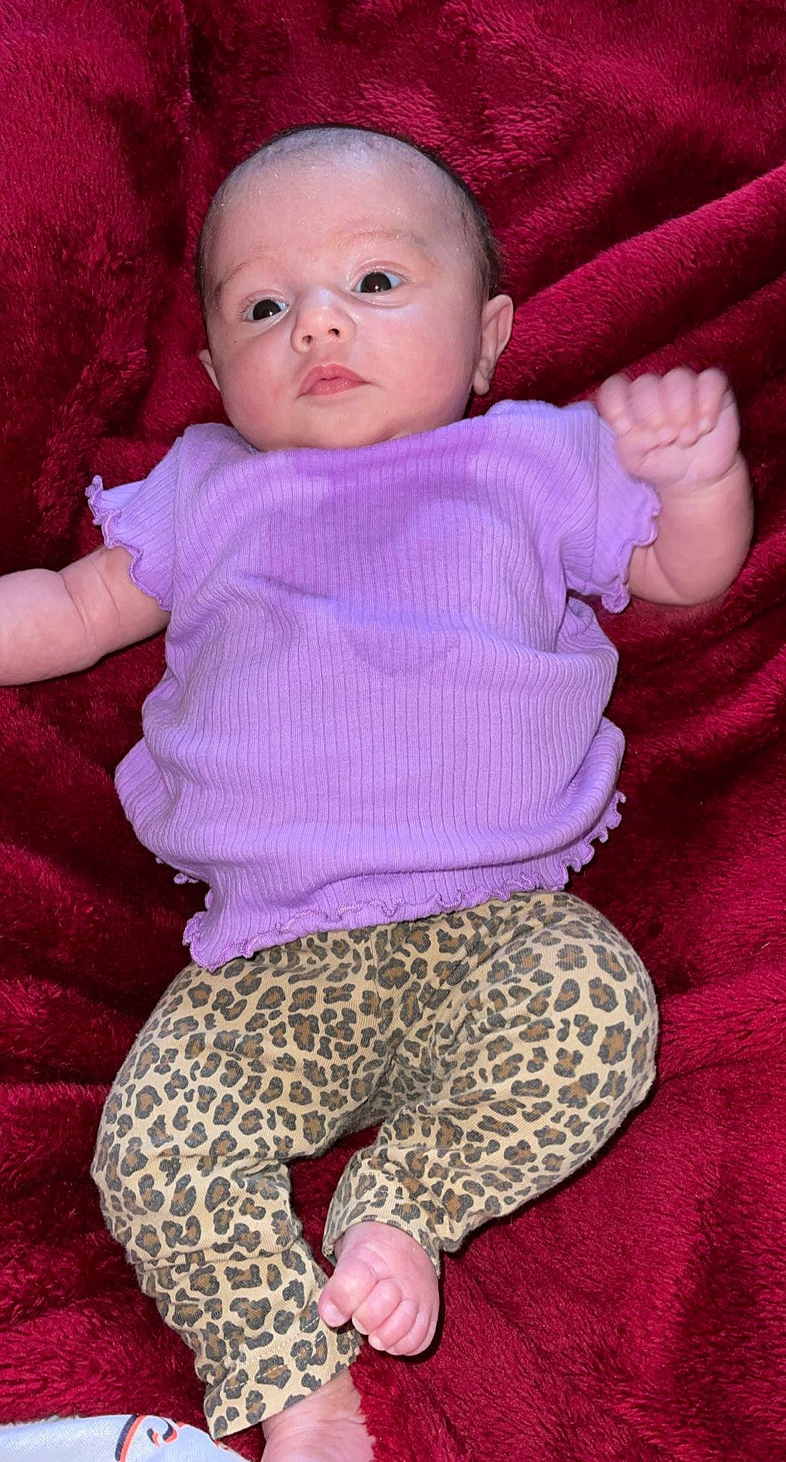 Liza is registered to the contest to win money with this photo: arm, baby, baby_toddler_clothing, cheek, comfort, face, head, human_body, lip, magenta, organ, person, pink, purple, red, skin, sleeve, textile, toddler, violet