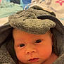 baby, blanket, bonnet, cap, clothing, face, happy, hat, head, hood, hoodie, knitwear, newborn, person, photography, portrait, quilt, sweater, sweatshirt, towel