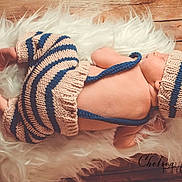 Finn is registered to the contest to win money with this photo: baby, beauty, child, crochet, ear, fashion_accessory, fur, hair_accessory, hand, headgear, leg, nap, outerwear, photography, textile, toddler, top, wool