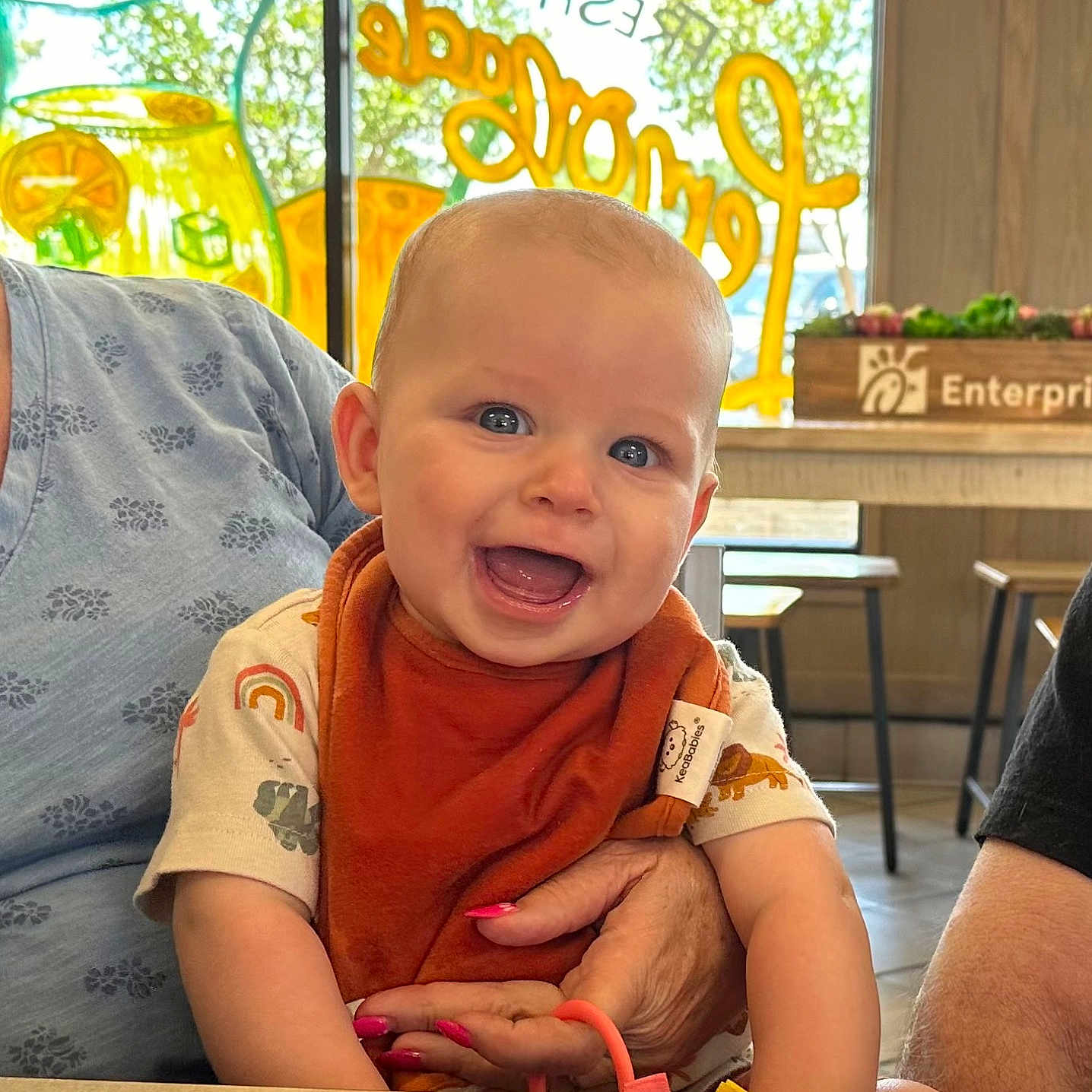 Isaac is registered to the contest to win money with this photo: adult, baby, babylaughing, clothing, diningtable, face, furniture, happy, head, indoors, male, man, person, photography, plant, portrait, pottedplant, sitting, t_shirt, table