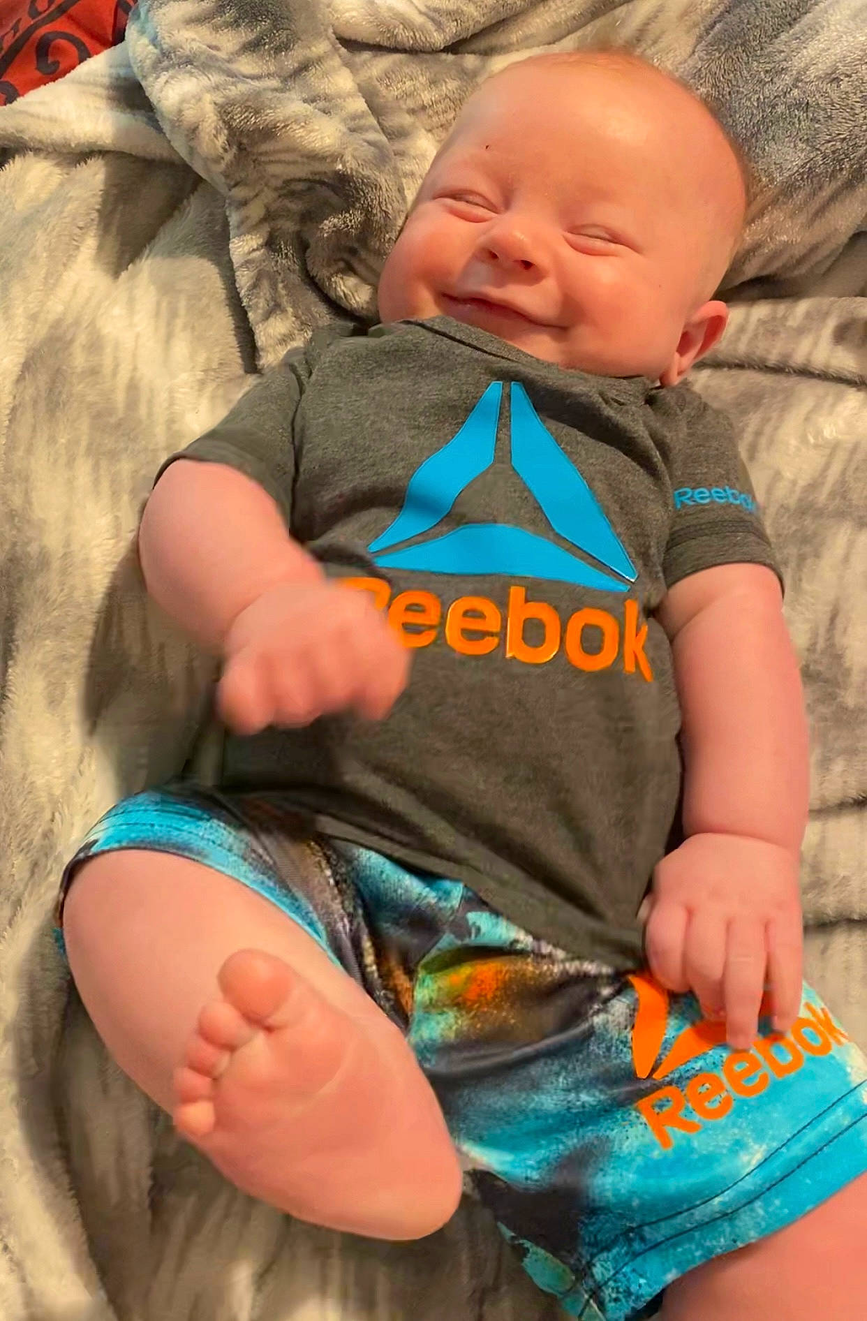 Oaklee is registered to the contest to win money with this photo: azure, baby, baby_toddler_clothing, comfort, cool, face, facial_expression, finger, fun, green, hand, head, human, human_body, leaf, leg, organ, person, product, skin
