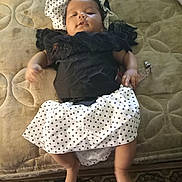 Kendall joined the competition — help win amazing prizes! baby, infant, polka_dot, black_clothing, white_clothing, mattress, bedroom, lying_down, child, cute, soft_texture, patterned_surface, indoors, sleepy, small_hands, small_feet, relaxed, clothing, person, headwear