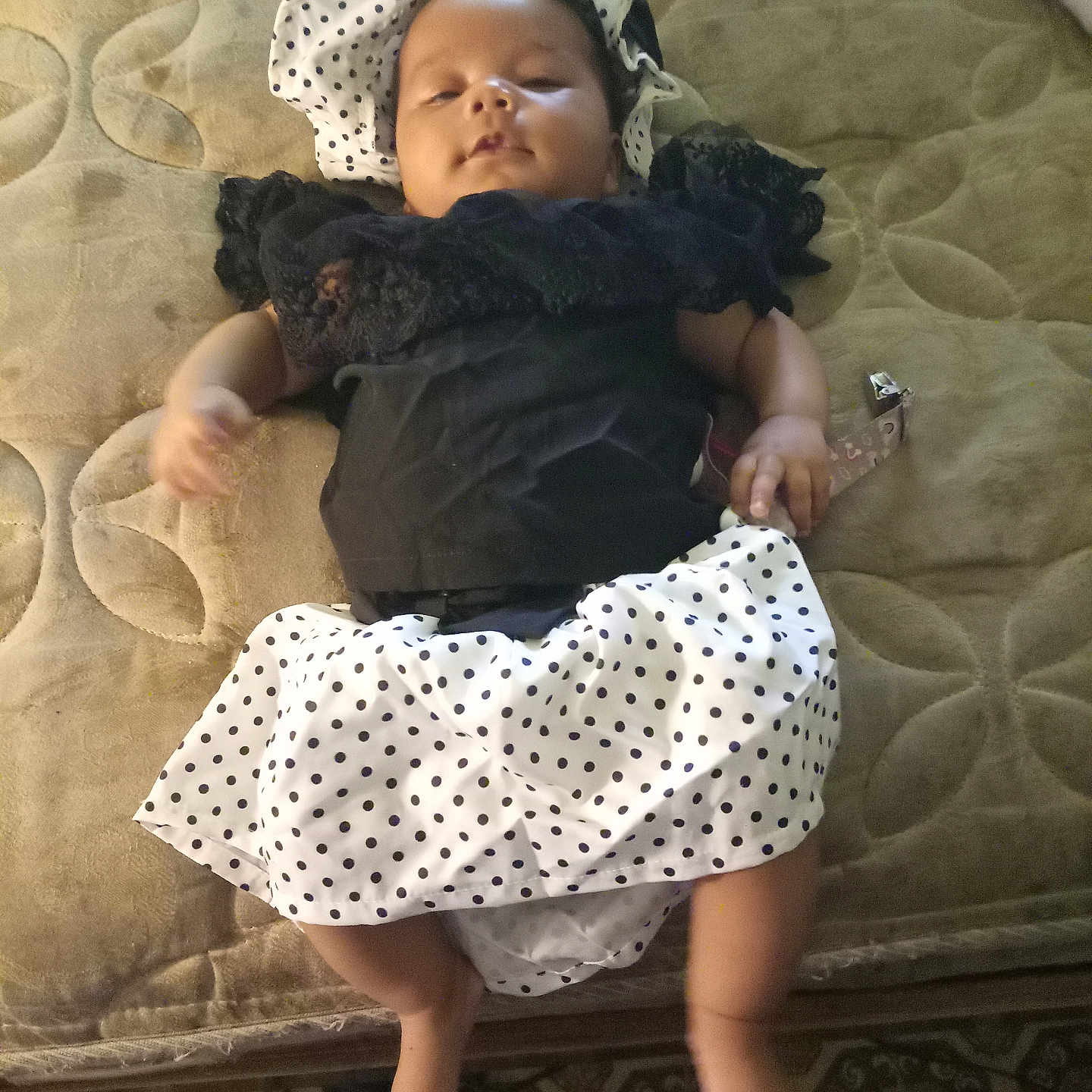 Kendall joined the competition — help win amazing prizes! baby, bedroom, black_clothing, child, clothing, cute, headwear, indoors, infant, lying_down, mattress, patterned_surface, person, polka_dot, relaxed, sleepy, small_feet, small_hands, soft_texture, white_clothing