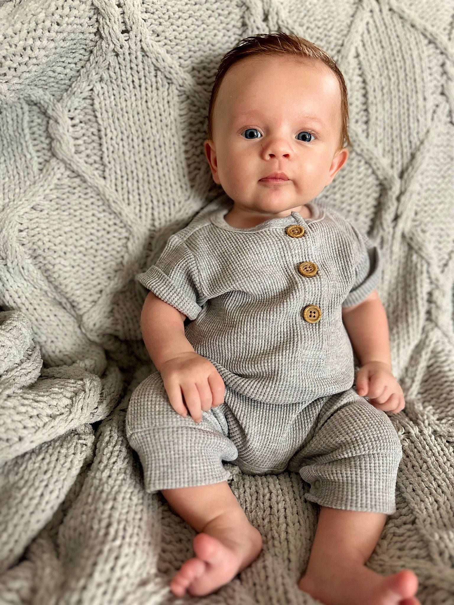 Beauden is registered to the contest to win money with this photo: baby, baby_toddler_clothing, cheek, child, collar, dress_shirt, eye, face, grey, head, iris, lip, pattern, person, sitting, skin, sleeve, standing, textile, toddler