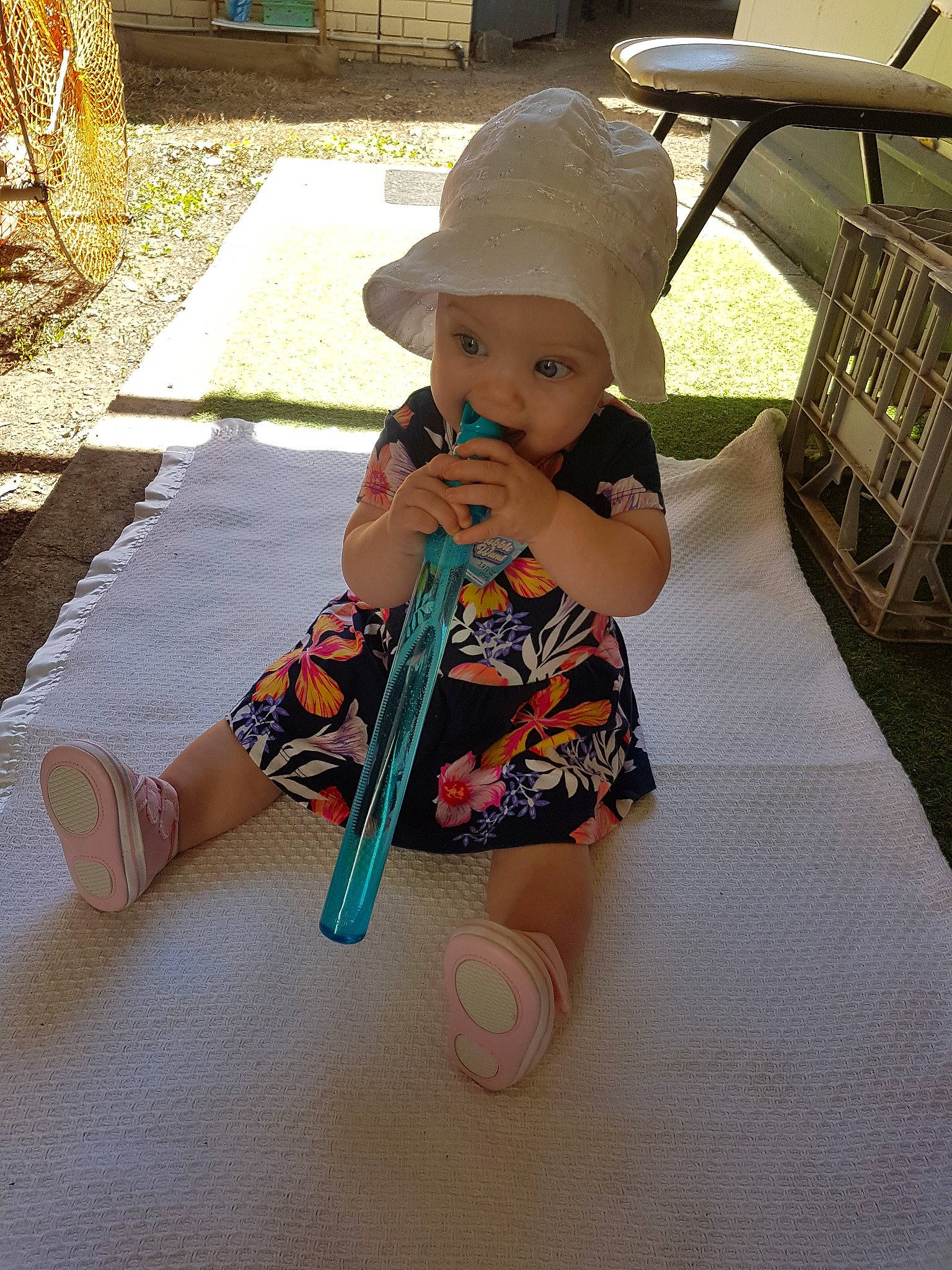 Constance joined the competition — help win amazing prizes! baby, cap, child, hat, headgear, headwear, person, play, shoe, sitting, skin, sun_hat, toddler, toy, vacation