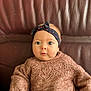 Sinaï participe au concours pour gagner de l'argent avec cette photo : baby, child, headband, sweater, knitted, blue_eyes, face, portrait, cute, infant, sitting, indoor, leather_couch, fashion, cozy, young_child, expression, person, closeup, adorable