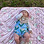 baby, blanket, outdoor, grass, toddler, child, sleeping, hat, socks, pattern, cute, hand, lying_down, peaceful, nature, floral, pink, teddy_bear, apparel, infant