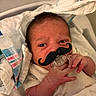 baby, baby_boy, baby_girl, child, clothing, cute, face, hand, hospital, hospital_blanket, indoors, infant, lying_down, mustache, newborn, newborn_baby, pacifier, portrait, skin, wrapped