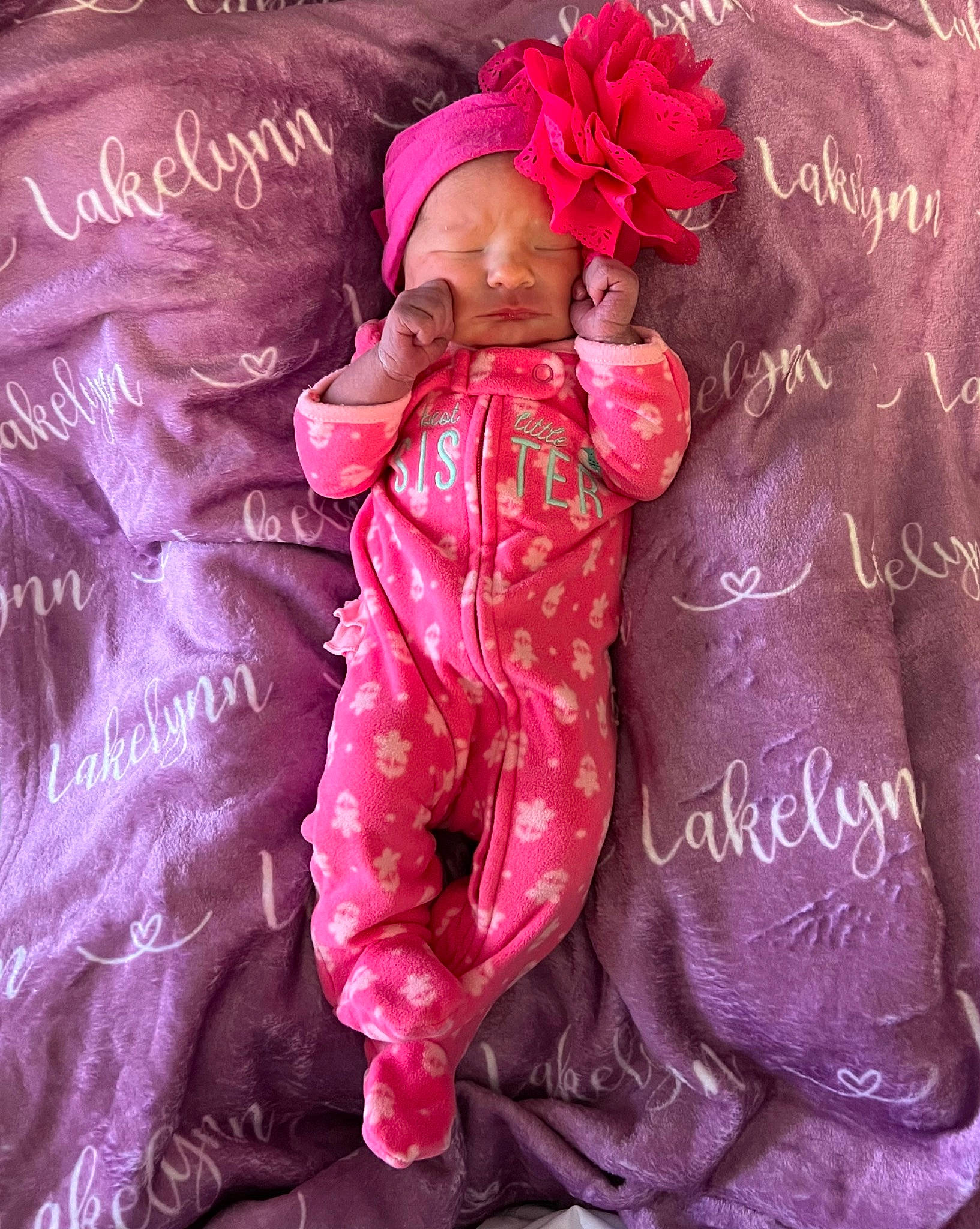 Lakelynn is registered to the contest to win money with this photo: baby_toddler_clothing, event, fashion_accessory, fictional_character, flower, font, gesture, happy, headpiece, linens, magenta, peach, person, petal, pink, purple, red, rose, satin, sleeve