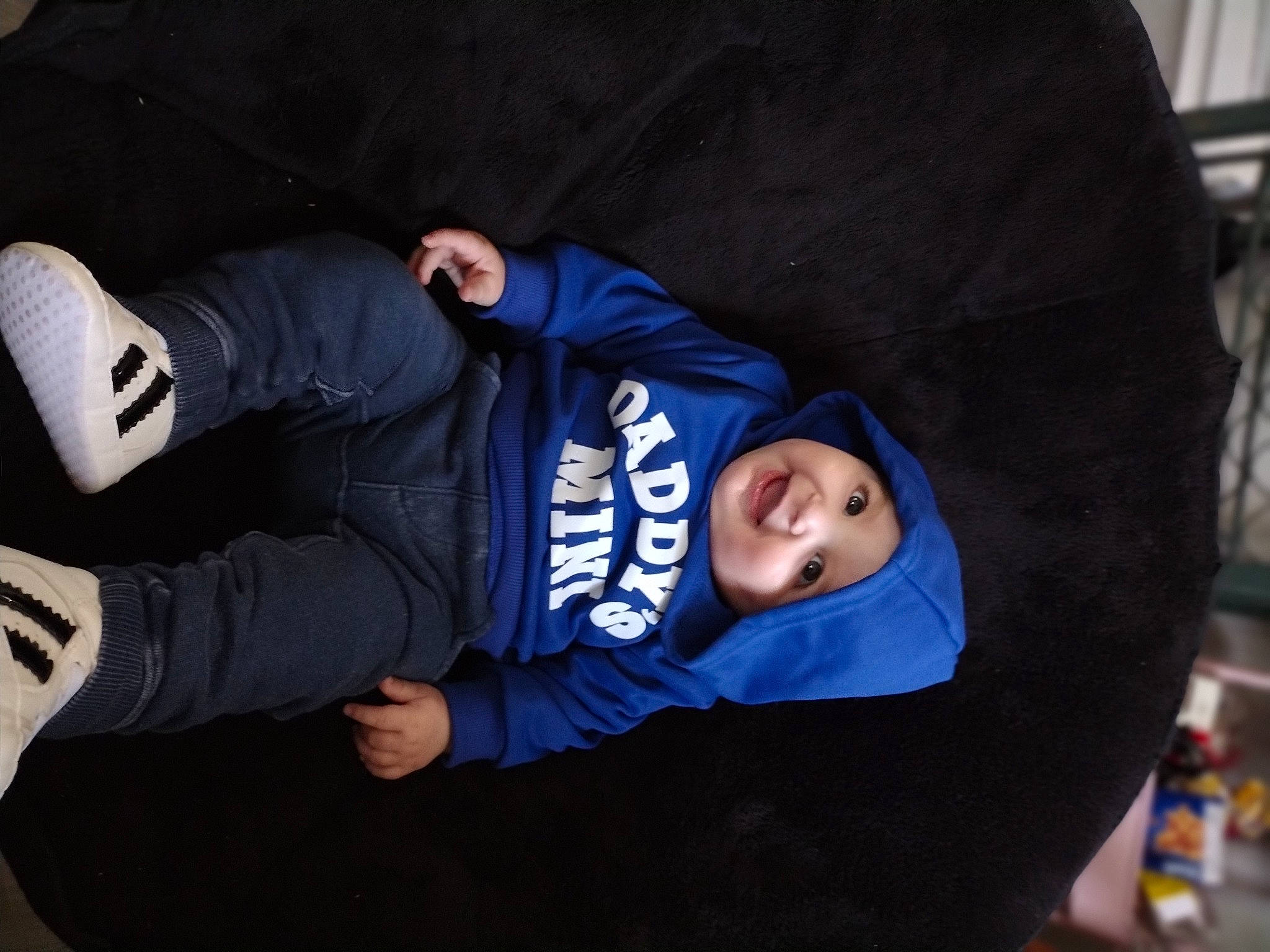 Sterling is registered to the contest to win money with this photo: child, comfort, denim, electric_blue, flash_photography, fun, glove, hat, headwear, hoodie, jacket, joy, outerwear, person, personal_protective_equipment, sitting, sleeve, sportswear, t_shirt, toddler