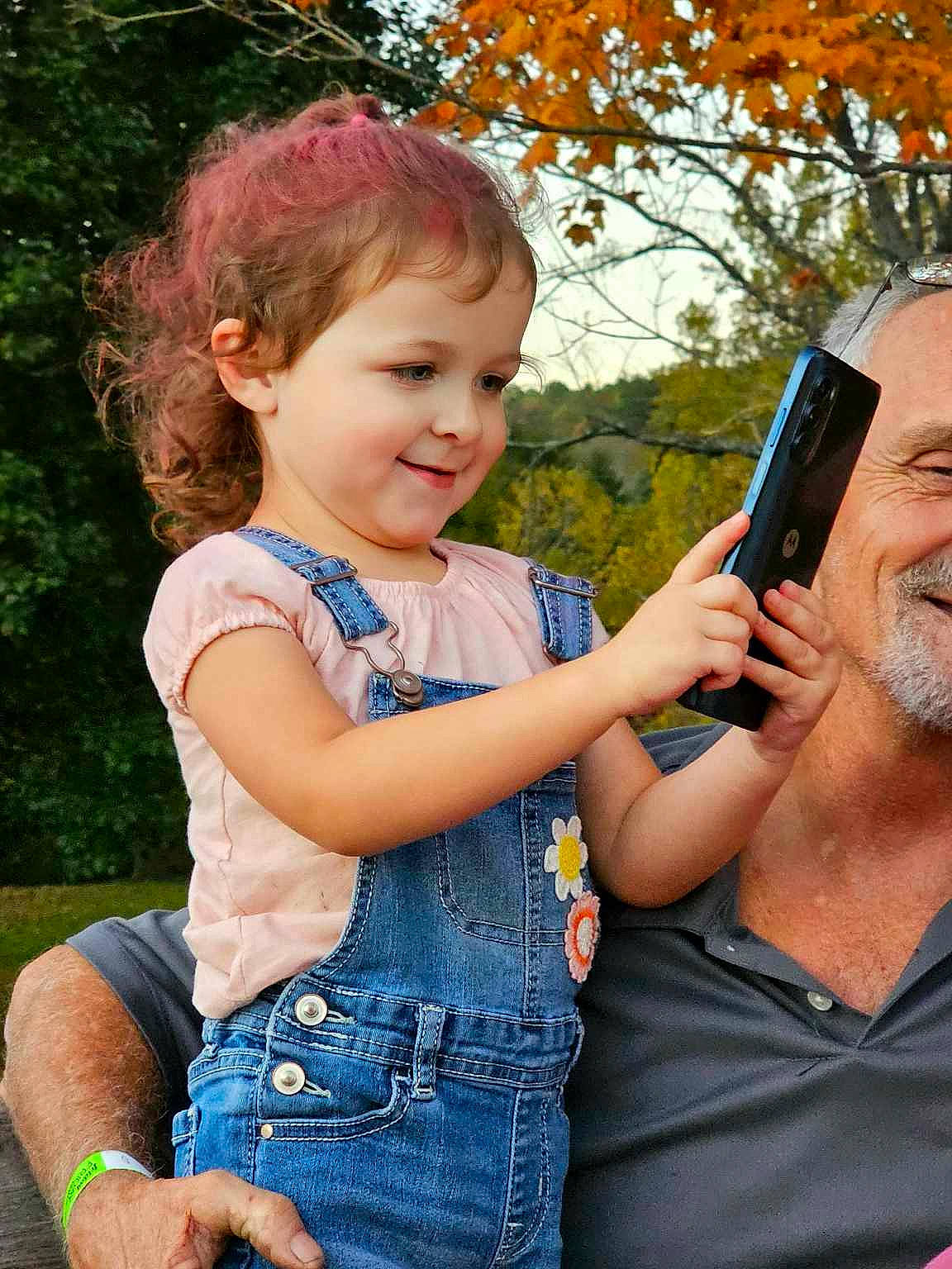 Ember is registered to the contest to win money with this photo: baby_toddler_clothing, child, communication_device, facial_expression, finger, fun, gesture, grass, happy, joy, leaf, leisure, mobile_phone, organ, people, people_in_nature, person, photograph, summer, telephony