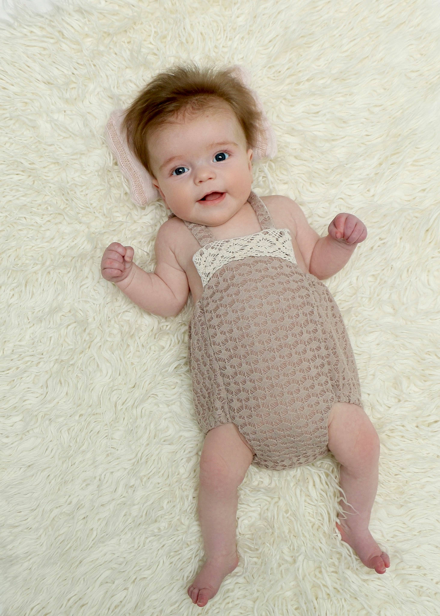 Violet is registered to the contest to win money with this photo: arm, baby_toddler_clothing, cheek, eye, fawn, finger, gesture, hair, head, human_body, iris, joint, leg, lip, one_piece_garment, person, pink, skin, sleeve, textile