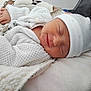 Lyana participe au concours pour gagner de l'argent avec cette photo : baby, sleeping, smile, hat, knitwear, blanket, cozy, infant, face, child, soft, warm, cute, resting, newborn, comfort, relaxed, clothing, portrait, indoors