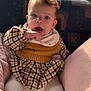 baby, child, cozy, cushion, dress, expression, eyes, face, hair, hand, indoors, infant, knitwear, natural_light, pink, plaid, portrait, sitting, window, yellow