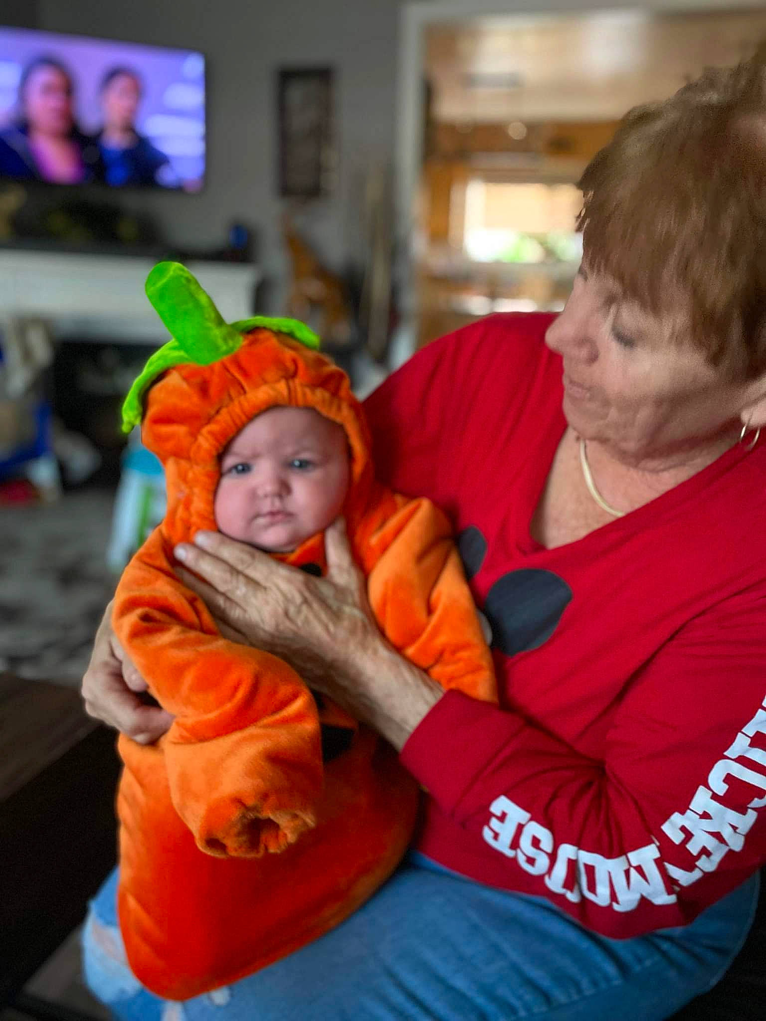 Mya joined the competition — help win amazing prizes! baby, blurred, child, couch, display_device, event, fun, happy, headwear, lap, led_backlit_lcd_display, leisure, orange, person, play, pumpkin, sitting, t_shirt, television, toddler