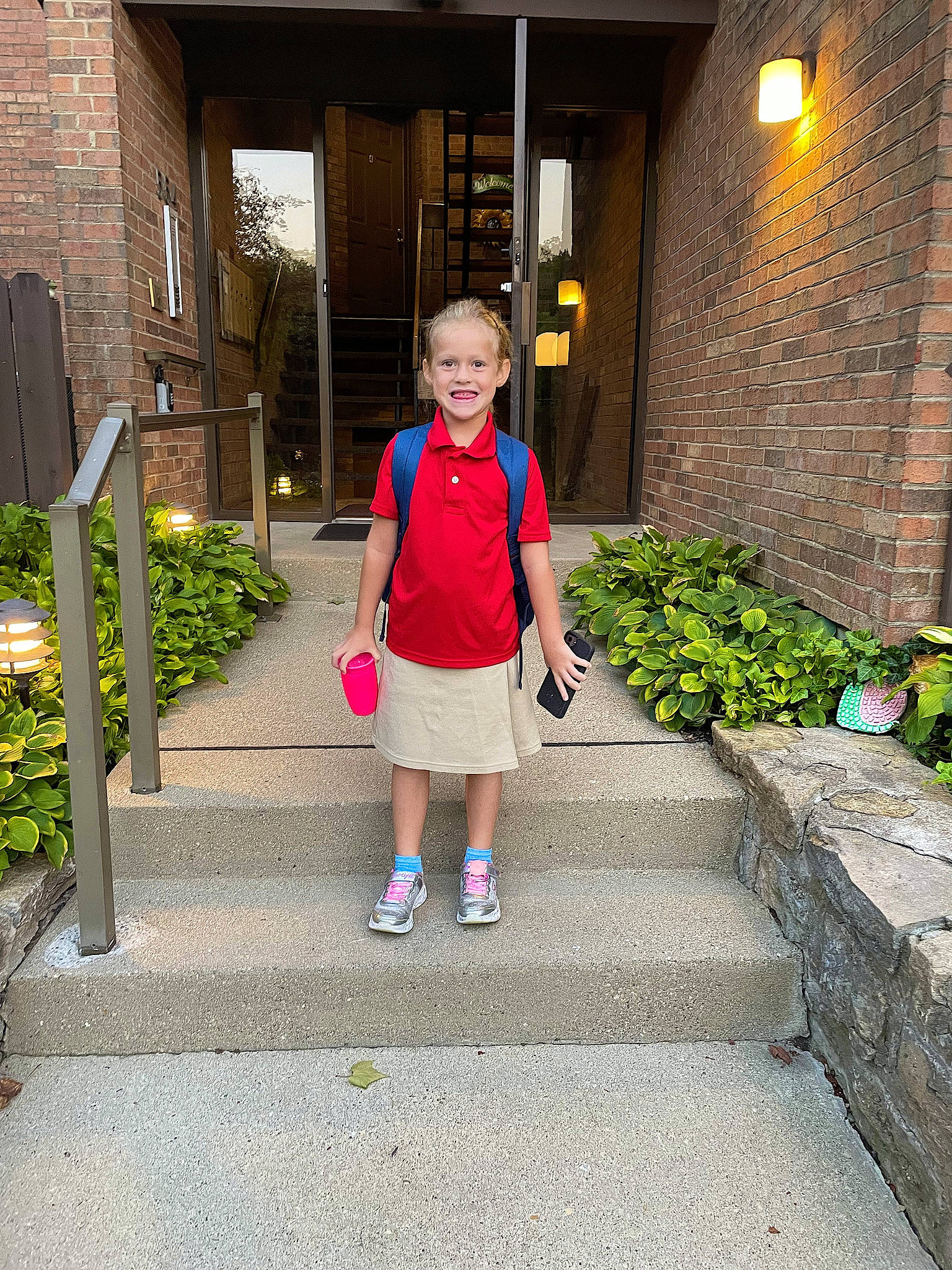 Jocelyn joined the competition — help win amazing prizes! bag, building, electric_blue, flooring, grass, home, human_leg, joy, leisure, luggage_and_bags, magenta, pedestrian, person, plant, road_surface, shorts, sidewalk, standing, t_shirt, toddler