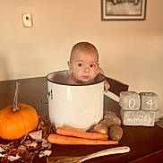 Cassidy joined the competition — help win amazing prizes! baby, infant, pot, table, pumpkin, carrots, potatoes, wooden_spoon, autumn, fall, decorations, home_interior, portrait, child, face, sitting, cute, kitchen, food, seasonal