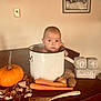 baby, infant, pot, table, pumpkin, carrots, potatoes, wooden_spoon, autumn, fall, decorations, home_interior, portrait, child, face, sitting, cute, kitchen, food, seasonal