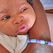 Matilda joined the competition — help win amazing prizes! baby, closeup, face, arm, tattoo, bracelet, beads, skin, expression, infant, person, clothing, white, resting, young, cute, child, portrait, indoors, soft