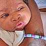 baby, closeup, face, arm, tattoo, bracelet, beads, skin, expression, infant, person, clothing, white, resting, young, cute, child, portrait, indoors, soft