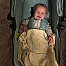 Greyson joined the competition — help win amazing prizes! baby, infant, child, smiling, happy, face, portrait, stroller, blanket, cozy, seated, indoor, carpet, baby_clothing, striped_outfit, green, yellow, caregiver_gear, close_up, safe