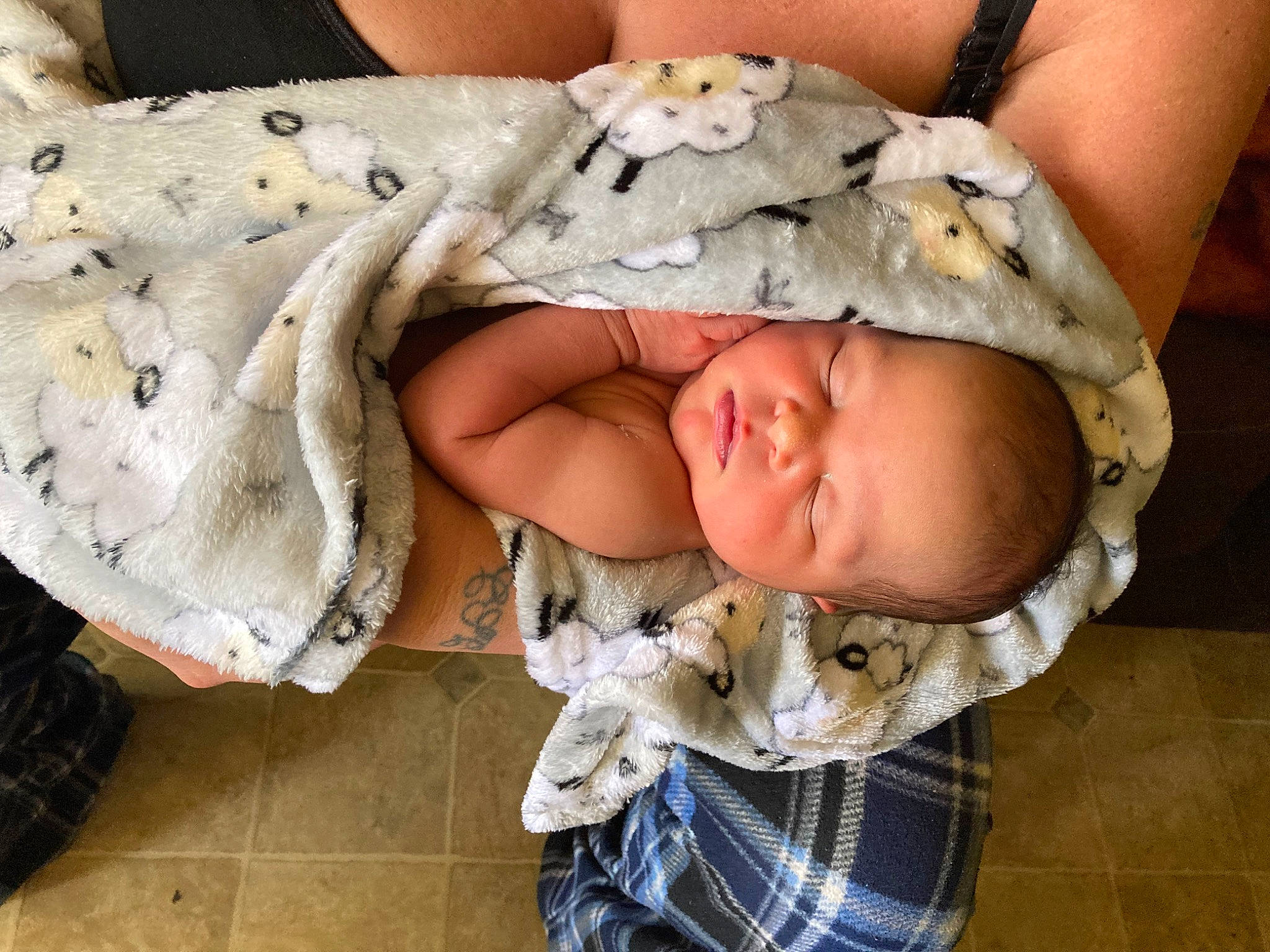 Ailani is registered to the contest to win money with this photo: baby, baby_products, baby_sleeping, baby_toddler_clothing, child, comfort, eye, fashion_accessory, finger, headgear, linens, pattern, person, plaid, sitting, skin, sleeve, tartan, textile, toddler