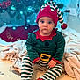 Sowen a rejoint le concours — aidez-le/la à gagner de superbes lots ! baby, blanket, blue_eyes, child, christmas, cute, decorations, elf_costume, expression, festive, floor_mat, hat, holiday, holiday_season, indoor, lights, portrait, seated, striped_clothing, toddler