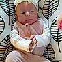 Bailey Lee is registered to the contest to win money with this photo: baby, infant, headband, flower, pink_clothing, white_clothing, patterned_cushion, leaf_pattern, hands, face, eyes, cute, soft_texture, seated, baby_garment, indoor, portrait, child, adorable, relaxed