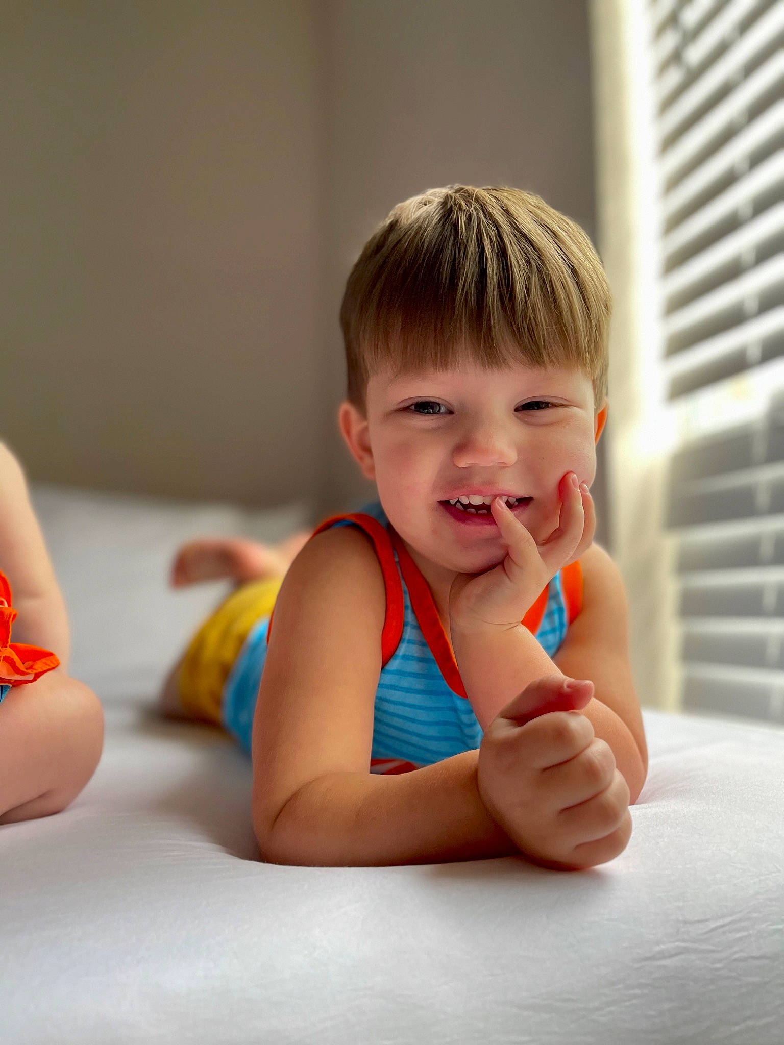 Brandon is registered to the contest to win money with this photo: arm, baby, baby_toddler_clothing, chest, child, comfort, elbow, finger, flooring, fun, gesture, hand, happy, human_leg, person, shoulder, sitting, skin, smile, thumb