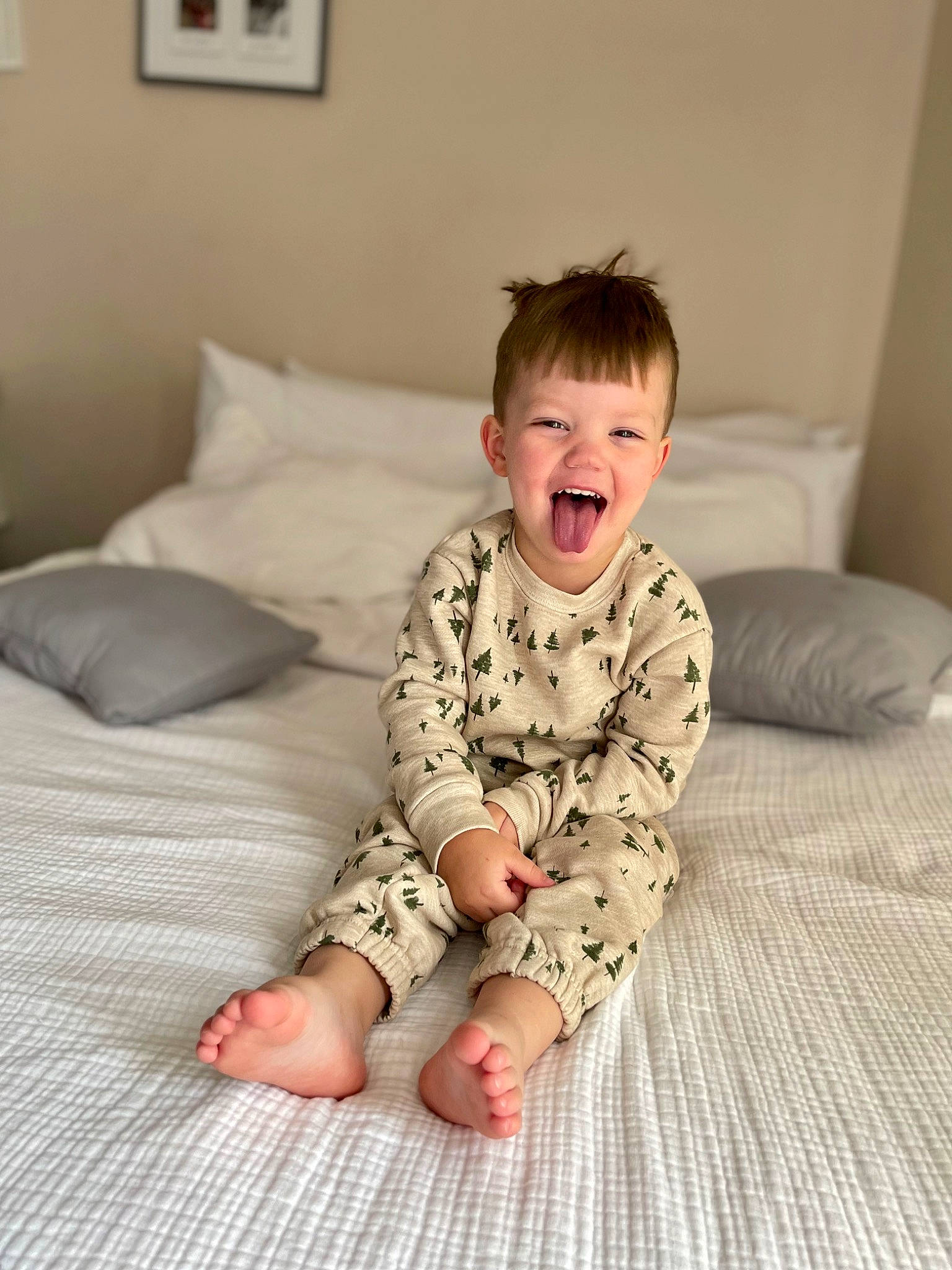 Brandon is registered to the contest to win money with this photo: baby, baby_toddler_clothing, child, comfort, floor, flooring, foot, happy, hardwood, knee, linens, pattern, person, picture_frame, sitting, skin, sleeve, smile, t_shirt, toddler