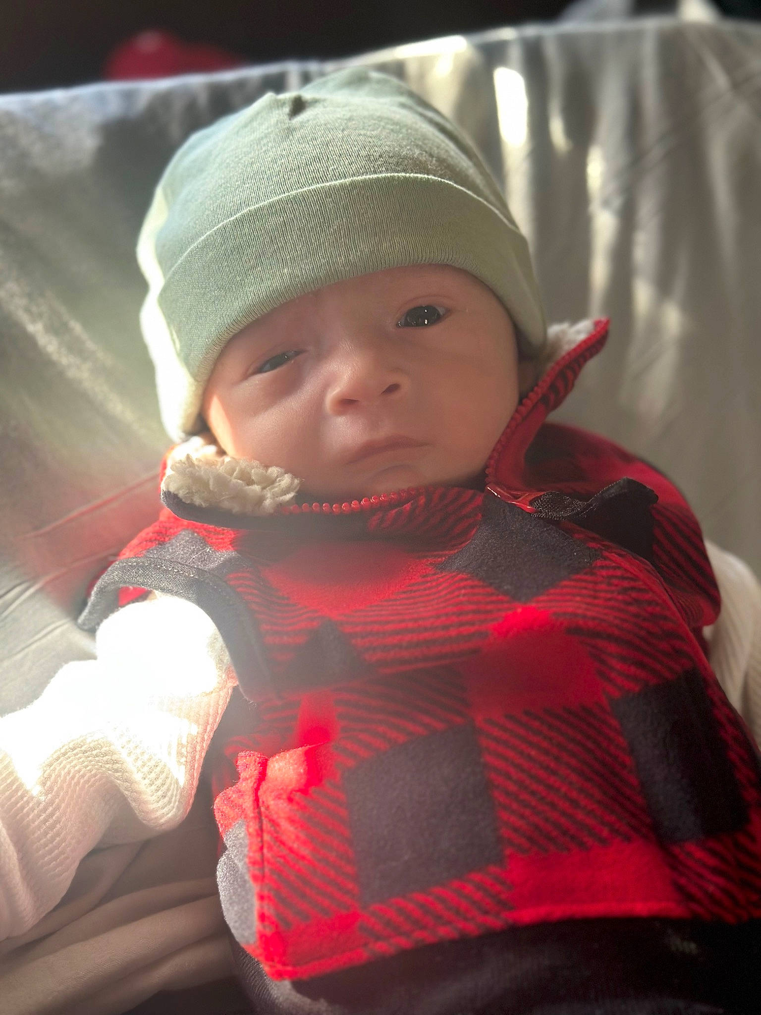 Ayden is registered to the contest to win money with this photo: baby, beanie, cap, carmine, child, comfort, fashion_accessory, fun, happy, headgear, headwear, knit_cap, lifejacket, outerwear, pattern, person, personal_protective_equipment, plaid, sitting, sleeve