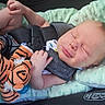 baby, blanket, car_seat, child, closeup, comfort, cute, indoors, infant, newborn, peaceful, plush_toy, resting, seatbelt, sleeping, soft, straps, tiger_toy, tiny_feet, tiny_hands