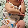 baby, infant, sleeping, onesie, animal_print, blanket, soft_texture, peaceful, cute, newborn, child, laying_down, skin, hand, foot, relaxation, indoors, portrait, closeup, comfort