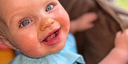 Rosina joined the competition — help win amazing prizes! baby, babylaughing, bodypart, clothing, couch, dress, face, finger, furniture, hand, happy, head, laughing, mouth, newborn, person, photography, portrait, smile, teeth