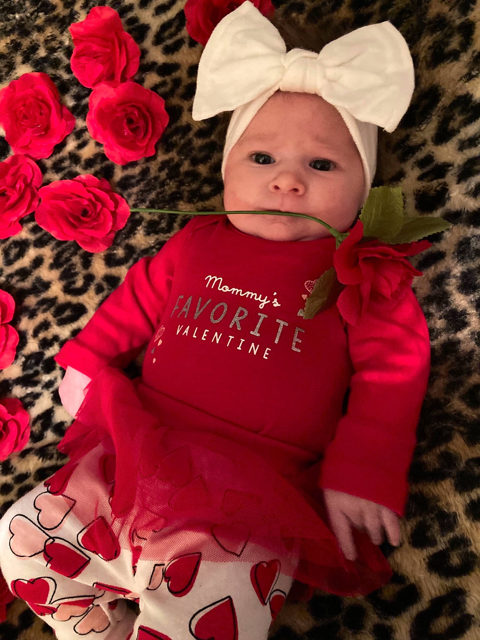 Harlee is registered to the contest to win money with this photo: baby, baby_toddler_clothing, beauty, cap, costume_hat, face, facial_expression, happy, hat, headwear, magenta, pattern, person, petal, pink, plant, red, skin, sleeve, t_shirt