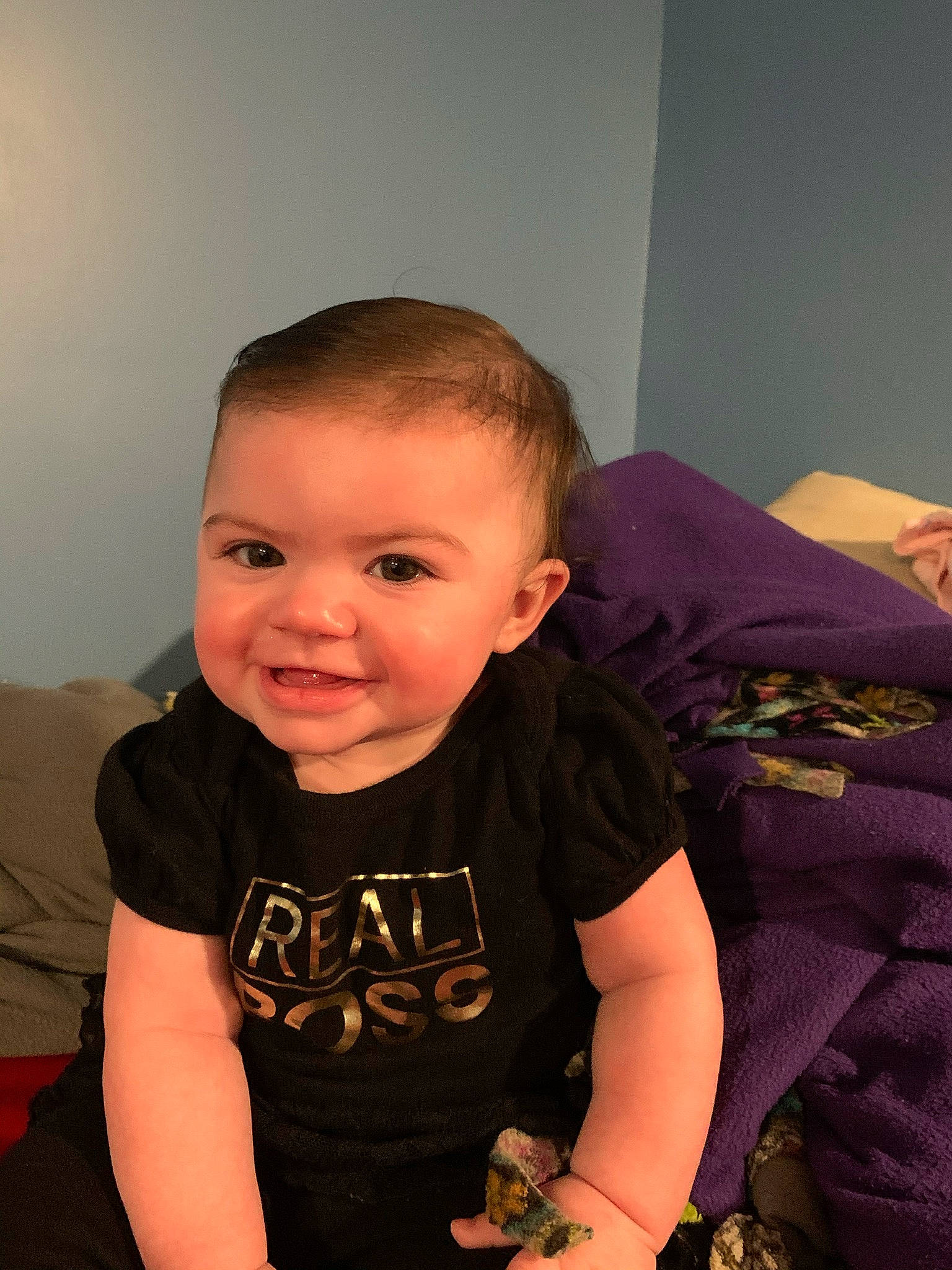 Juliana is registered to the contest to win money with this photo: baby, baby_toddler_clothing, bracelet, buzz_cut, cheek, ear, iris, joy, long_sleeved_t_shirt, person, purple, skin, toddler, wrist