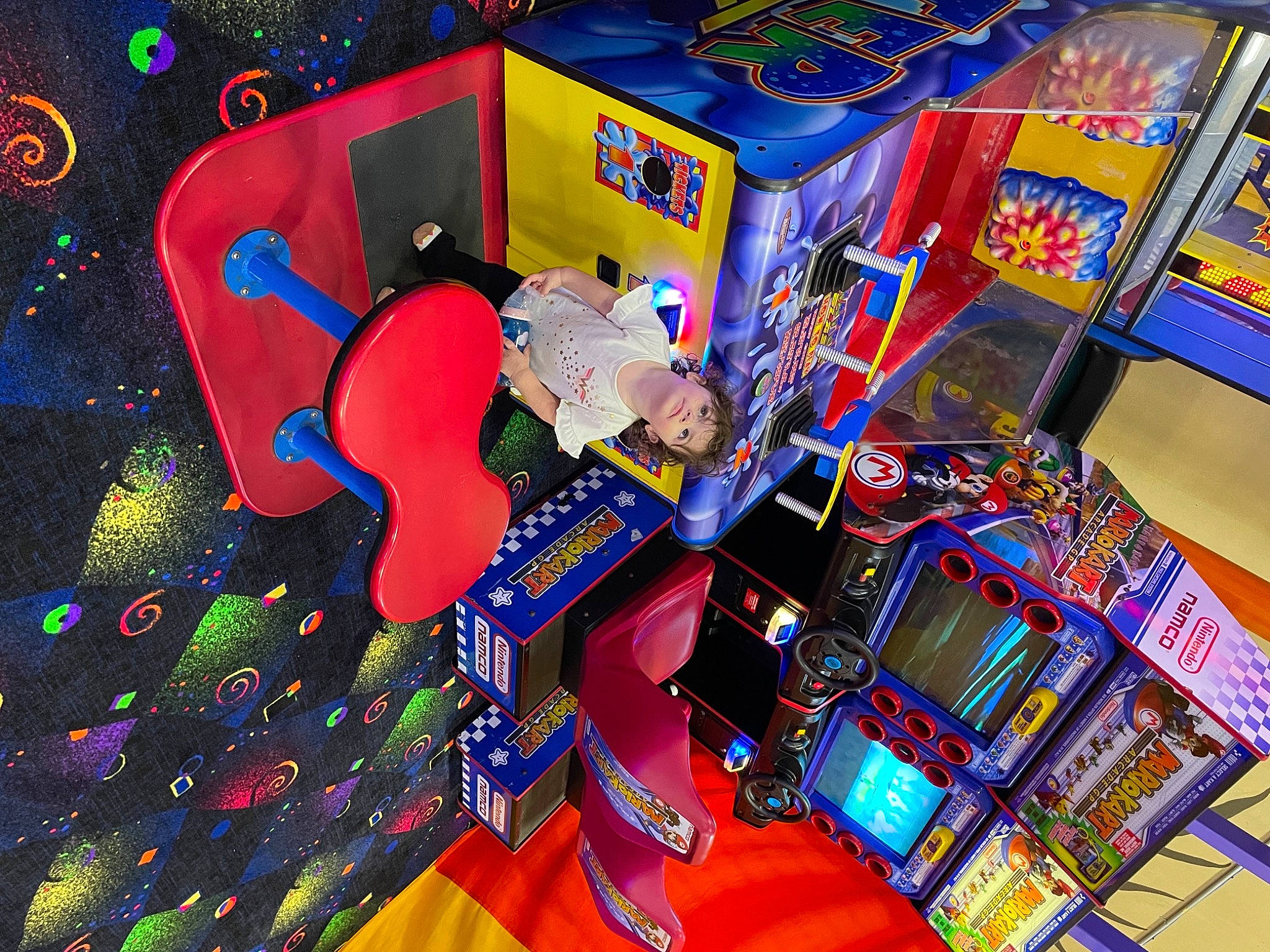 Juliana is registered to the contest to win money with this photo: arcade_game, art, box, carmine, electric_blue, event, font, fun, games, graphic_design, graphics, machine, magenta, packaging_and_labeling, person, plastic, recreation, snack, space, technology