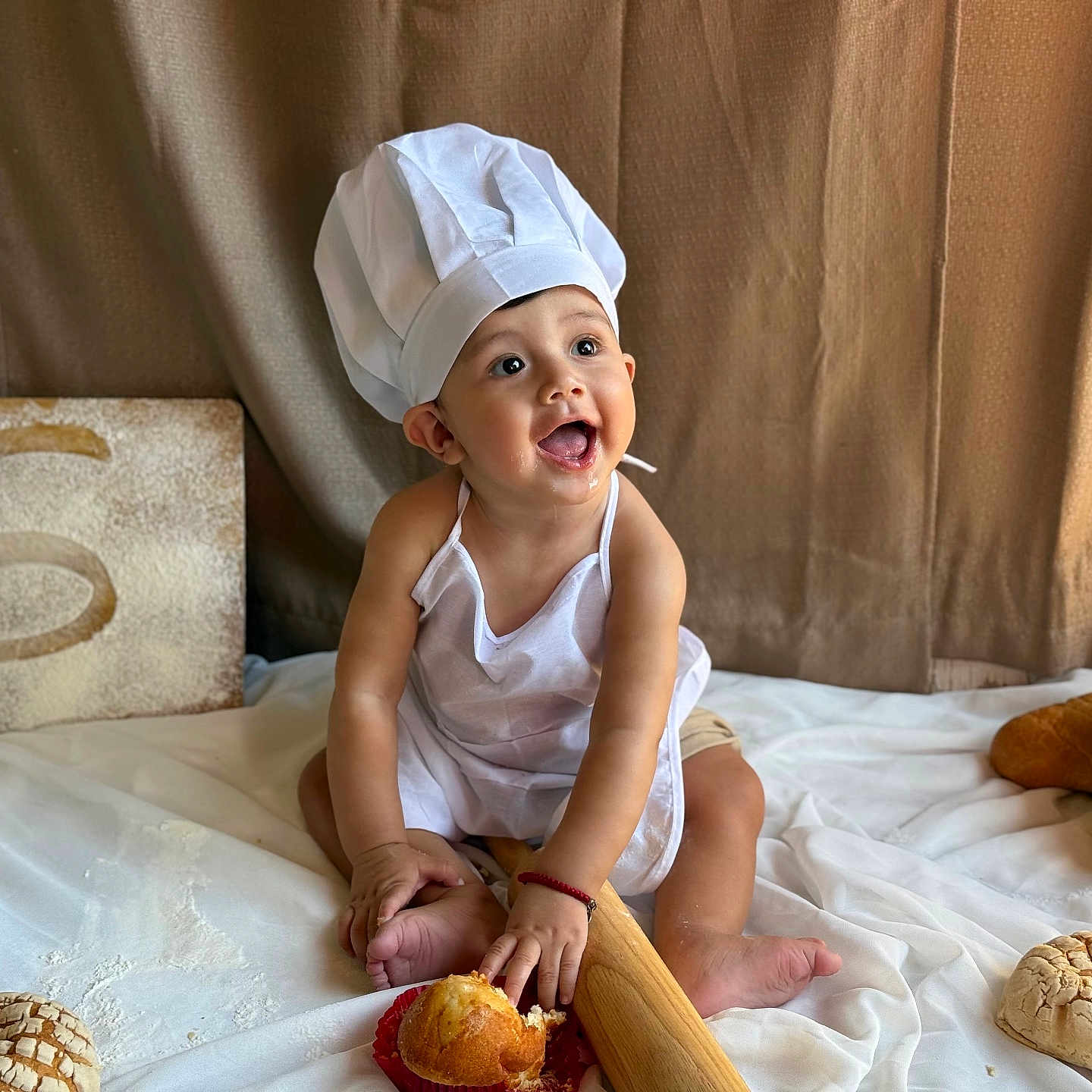 Luis Adriel is registered to the contest to win money with this photo: apron, baby, baking, bread, chef_hat, child, cooking, cute, food, happy, indoors, infant, kitchen, pastries, playful, portrait, rolling_pin, sitting, smile, white_cloth