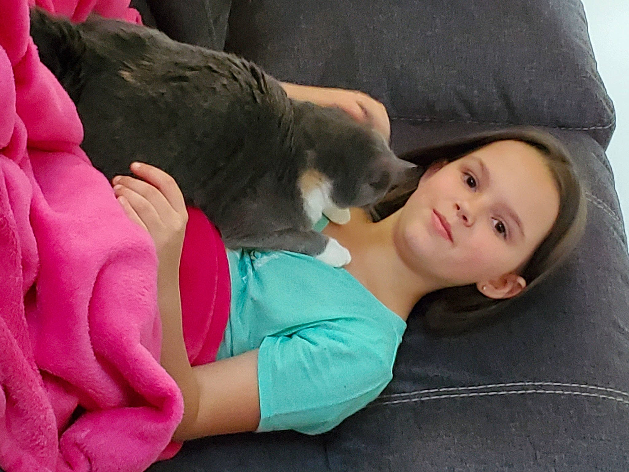 Traci is registered to the contest to win money with this photo: black_hair, canidae, carnivore, child, comfort, companion_dog, dog_breed, fawn, fur, gesture, grass, hand, happy, human_leg, lap, leisure, magenta, person, sitting, skin