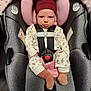 baby, car_seat, child, infant, pajamas, socks, hat, safety_harness, pink, gray, seat, cute, face, tongue, expression, indoors, fabric, pattern, small_person, child_safety