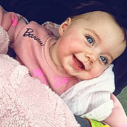 Liz participe au concours pour gagner de l'argent avec cette photo : baby, blanket, blue_eyes, child, closeup, cozy, cute, face, happy, headband, indoors, infant, person, pink_sweater, playful, smiling, soft, toddler, toy, warm