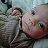 Jaxson joined the competition — help win amazing prizes! baby, infant, face, eyes, clothing, ribbed_sweater, blanket, soft, closeup, lying_down, cute, young_child, portrait, indoors, resting, skin, person, newborn, cozy, warm