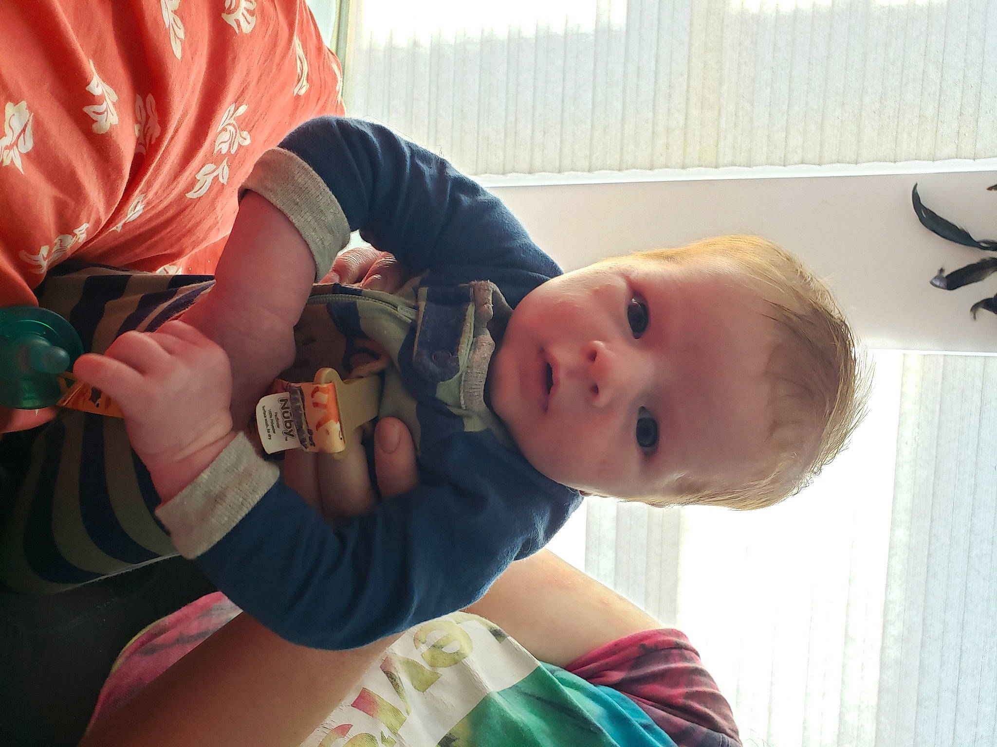 Calvin is registered to the contest to win money with this photo: abdomen, arm, baby, baby_products, baby_toddler_clothing, cheek, child, comfort, elbow, finger, fun, hand, happy, nail, person, sitting, skin, smile, thumb, toddler