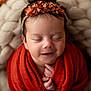 baby, infant, sleeping, flower_headband, red_blanket, basket, cozy, hands, closed_eyes, soft_texture, cute, newborn, portrait, peaceful, indoors, skin, hair, child, resting, warm