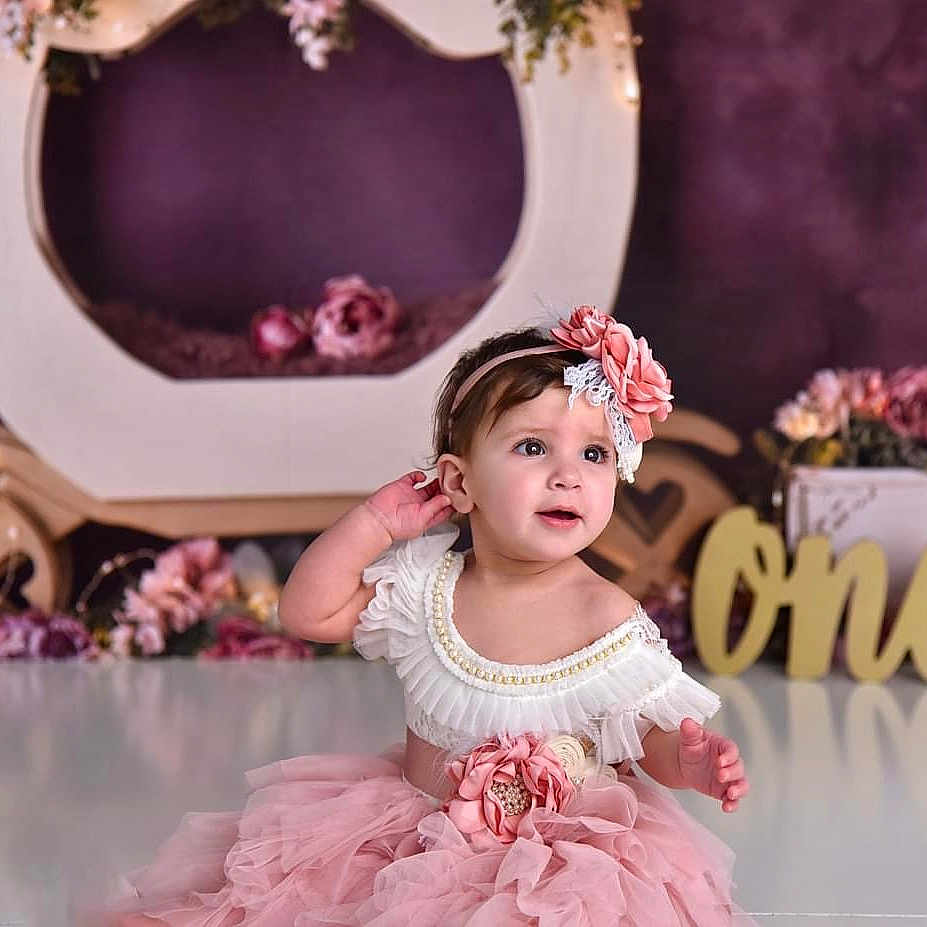Amaya is registered to the contest to win money with this photo: baby, birthdaycake, cake, clothing, cream, dancing, dessert, dress, face, flower, food, hair, head, leisureactivities, people, performer, person, sitting, sleeve, soloperformance
