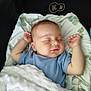 baby, sleeping, blanket, blue_clothing, cushion, face, infant, peaceful, resting, soft_texture, toddler, young_child, cute, indoors, portrait, head, comfort, relaxation, sleep, child