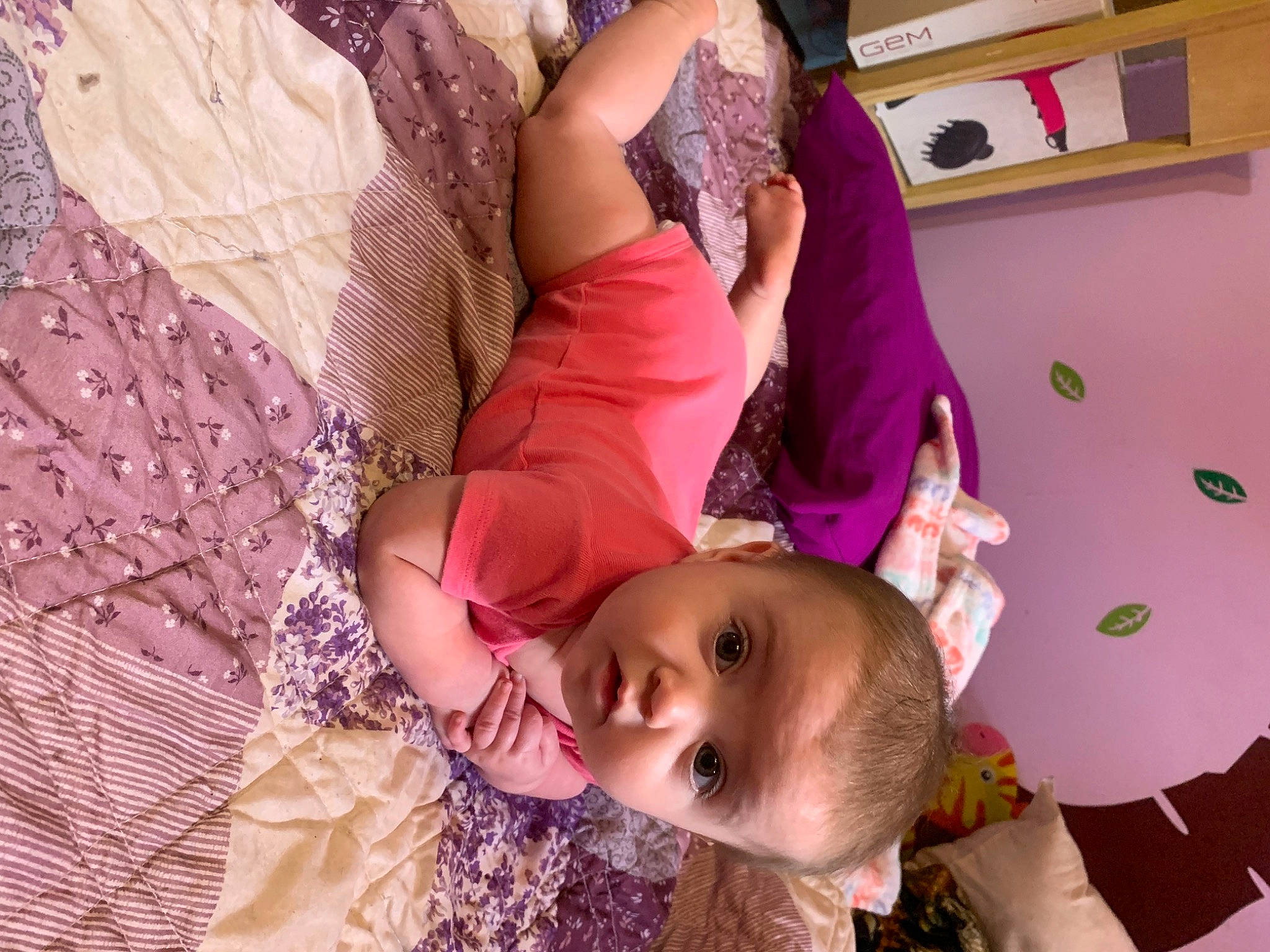 Rylee is registered to the contest to win money with this photo: abdomen, baby, baby_toddler_clothing, cheek, child, comfort, eyelash, fun, gesture, happy, human_body, magenta, mouth, pattern, person, pink, purple, room, skin, thigh