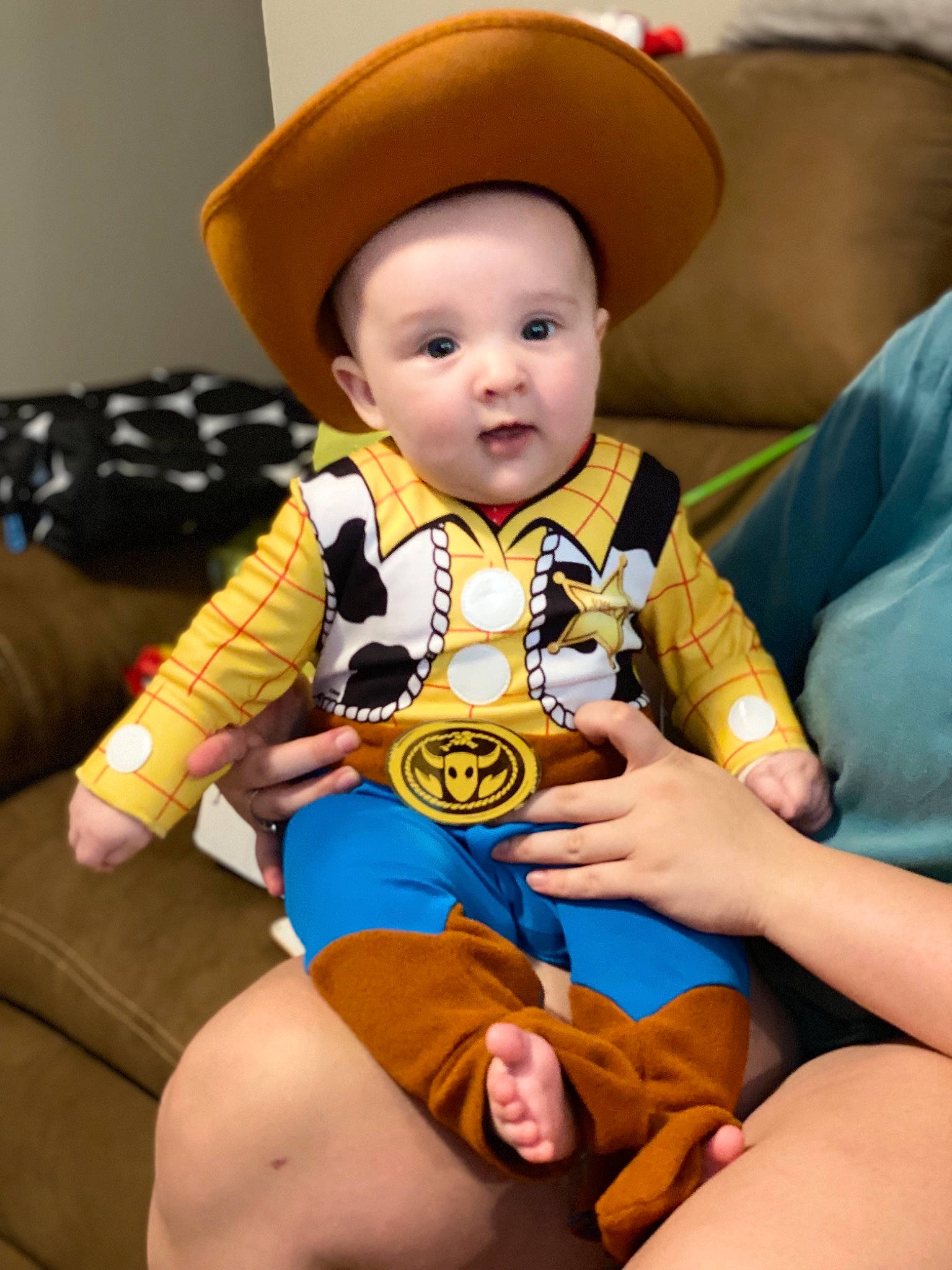 Dax is registered to the contest to win money with this photo: baby, baby_products, baby_toddler_clothing, child, comfort, costume_hat, fashion_accessory, foot, fun, happy, hat, human_body, human_leg, lap, person, sitting, smile, sun_hat, thigh, toddler